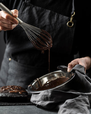 Chef whisking chocolate ganache made with couverture chocolate